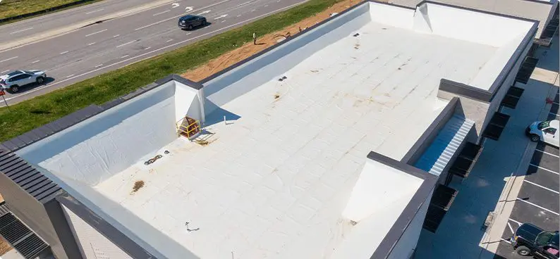 a commercial property with a flat roof in need of replacement